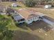 Aerial view of a ranch-style house with a large yard and outbuildings at 20635 Sw 63Rd Pl, Dunnellon, FL 34431