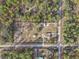 High-angle view showcasing a house on a spacious lot with surrounding trees at 20635 Sw 63Rd Pl, Dunnellon, FL 34431