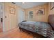 Bedroom with wood floors, double bed and wood walls at 20635 Sw 63Rd Pl, Dunnellon, FL 34431