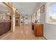 Bright hallway with hardwood floors, leading to various rooms at 20635 Sw 63Rd Pl, Dunnellon, FL 34431