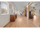 Long hallway with light hardwood floors and antique furniture at 20635 Sw 63Rd Pl, Dunnellon, FL 34431