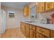 Bright kitchen with wood cabinets, laminate flooring and white appliances at 20635 Sw 63Rd Pl, Dunnellon, FL 34431