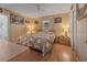 Main bedroom with king-size bed and wood walls at 20635 Sw 63Rd Pl, Dunnellon, FL 34431