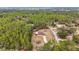 Aerial view of a home situated on a lot with mature trees and a long driveway at 21590 Sw 84Th Loop, Dunnellon, FL 34431