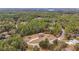 Aerial view of a house on a tree-lined street in a quiet neighborhood at 21590 Sw 84Th Loop, Dunnellon, FL 34431