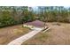 Aerial view of a single-story house with a driveway and attached garage at 21590 Sw 84Th Loop, Dunnellon, FL 34431