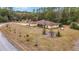 Aerial view of a single-Gathering home with a large lot and lush landscaping at 21590 Sw 84Th Loop, Dunnellon, FL 34431