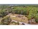 Aerial view of a house nestled in a wooded area with a long driveway at 21590 Sw 84Th Loop, Dunnellon, FL 34431