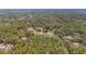 Aerial view of a home with a large backyard and surrounding trees at 21590 Sw 84Th Loop, Dunnellon, FL 34431