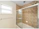 Clean bathroom with tiled shower and window at 21590 Sw 84Th Loop, Dunnellon, FL 34431