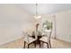 Charming dining room with round glass table and four light beige chairs at 21590 Sw 84Th Loop, Dunnellon, FL 34431