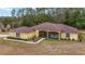 Exterior of a single-story house with a covered porch and landscaped yard at 21590 Sw 84Th Loop, Dunnellon, FL 34431