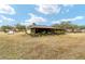 Back of house with large screened porch and yard at 21590 Sw 84Th Loop, Dunnellon, FL 34431