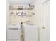 Bright laundry room with washer, dryer, and ample shelving at 21590 Sw 84Th Loop, Dunnellon, FL 34431