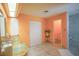 Bathroom with double sinks, orange walls, and walk-in shower at 2831 Sw 139Th St, Ocala, FL 34473