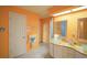 Bathroom with double sinks, orange walls and a walk-in shower at 2831 Sw 139Th St, Ocala, FL 34473