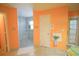 Bathroom with walk-in shower and orange walls at 2831 Sw 139Th St, Ocala, FL 34473