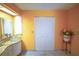 Bathroom with double sinks, orange walls, and large closet at 2831 Sw 139Th St, Ocala, FL 34473