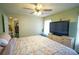 Large bedroom with a floral comforter and large TV at 2831 Sw 139Th St, Ocala, FL 34473