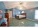 Spacious bedroom with blue walls and a large bed at 2831 Sw 139Th St, Ocala, FL 34473