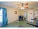 Bright bedroom with tiled floors, ceiling fan, and ample closet space at 2831 Sw 139Th St, Ocala, FL 34473