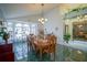 Bright dining room featuring a large table, chandelier, and green tile floors at 2831 Sw 139Th St, Ocala, FL 34473