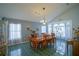 Formal dining room with wood table, chandelier, and green tile floors at 2831 Sw 139Th St, Ocala, FL 34473