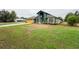 Eye-catching green house with a yellow garage door and lush green lawn at 2831 Sw 139Th St, Ocala, FL 34473