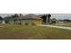 House exterior showcasing a yellow garage door and well-manicured lawn at 2831 Sw 139Th St, Ocala, FL 34473