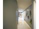 Long hallway with gray walls and white tile floors at 2831 Sw 139Th St, Ocala, FL 34473