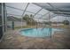 Enclosed kidney-shaped pool with tiled deck at 2831 Sw 139Th St, Ocala, FL 34473