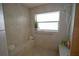 Walk-in shower with tiled walls and built-in seat at 2831 Sw 139Th St, Ocala, FL 34473