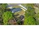 Aerial view showing the house's backyard and surrounding trees at 307 Marion Oaks Pass, Ocala, FL 34473