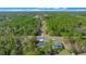 Aerial view of two houses and a quiet, tree-lined street at 307 Marion Oaks Pass, Ocala, FL 34473