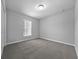 Bright bedroom with grey carpet, large closet, and window at 307 Marion Oaks Pass, Ocala, FL 34473