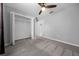 Bedroom with grey carpet, ceiling fan, and large closet at 307 Marion Oaks Pass, Ocala, FL 34473