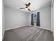 Well-lit bedroom featuring grey carpet and ceiling fan at 307 Marion Oaks Pass, Ocala, FL 34473