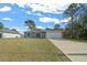 Newly built home with gray exterior, white garage door, and landscaped lawn at 307 Marion Oaks Pass, Ocala, FL 34473