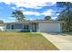 Newly built home with gray exterior, white garage door, and landscaped lawn at 307 Marion Oaks Pass, Ocala, FL 34473