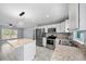 Close-up of the kitchen area with stainless steel appliances, white cabinets, and granite counters at 307 Marion Oaks Pass, Ocala, FL 34473