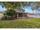 Landscaped backyard with a two story home and screened porch at 4074 Sw 47Th Ct, Ocala, FL 34474