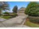 Attached garage with a driveway and well-manicured lawn at 4074 Sw 47Th Ct, Ocala, FL 34474