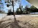 Backyard with large tree and white privacy fence at 4310 Se 139Th Pl, Summerfield, FL 34491