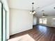 Dining area with hardwood floors and a modern light fixture at 4310 Se 139Th Pl, Summerfield, FL 34491