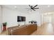 Living room with brown leather sectional sofa and a large TV at 4388 Sw 56Th Pl, Ocala, FL 34474