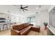 Living room with leather sectional sofa, kitchen island, and sliding glass doors at 4388 Sw 56Th Pl, Ocala, FL 34474