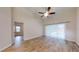 Main bedroom with hardwood floors and sliding doors to backyard at 4475 Se 48Th Place Rd, Ocala, FL 34480