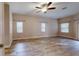 Large main bedroom with hardwood floors and multiple windows at 4475 Se 48Th Place Rd, Ocala, FL 34480