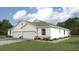 Two-car garage, light colored exterior, landscaping at 4748 Nw 39Th Street Rd, Ocala, FL 34482