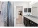 Modern bathroom with granite vanity and view of kitchen at 5050 Sw 91 Pl, Ocala, FL 34476